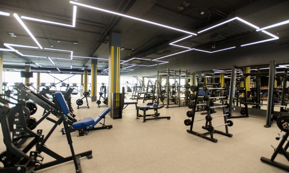modern gym with weightlifting equipment and workout machines